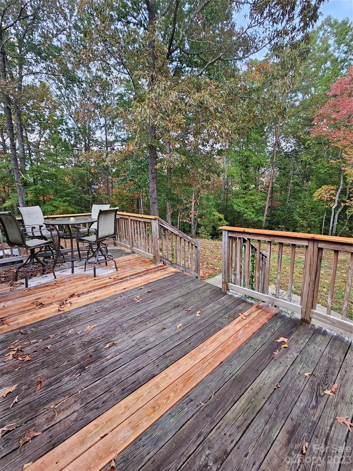 224 McDaniel Road Blacksburg, SC 29702 - Photo 19 of 20 a view of a patio with dining table and chairs with wooden floor and fence