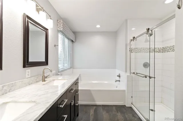 a bathroom with a double vanity sink and a mirror
