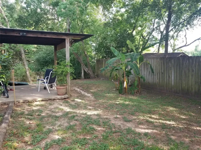 a backyard of a house with table and chairs