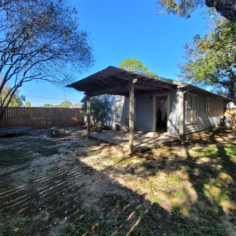 a backyard of a house with table and chairs