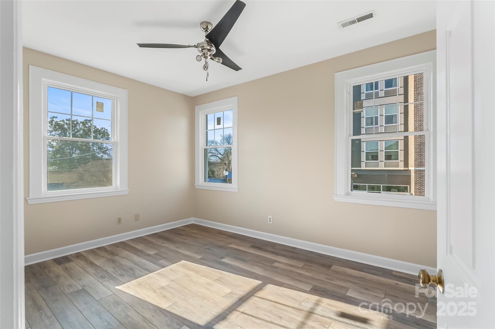 308 North Green Street, Unit 6 Morganton, NC 28655 - Photo 14 of 21 a view of an empty room with a window and wooden floor