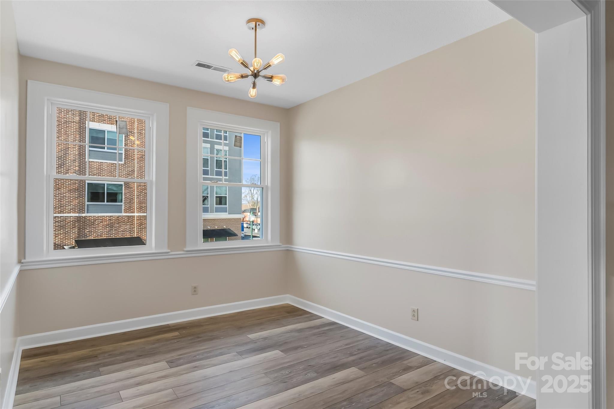 308 North Green Street, Unit 6 Morganton, NC 28655 - Photo 9 of 21 wooden floor in an empty room with a window