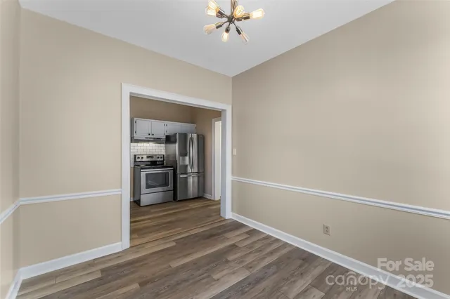 a view of a kitchen with a sink a ceiling fan and a stove