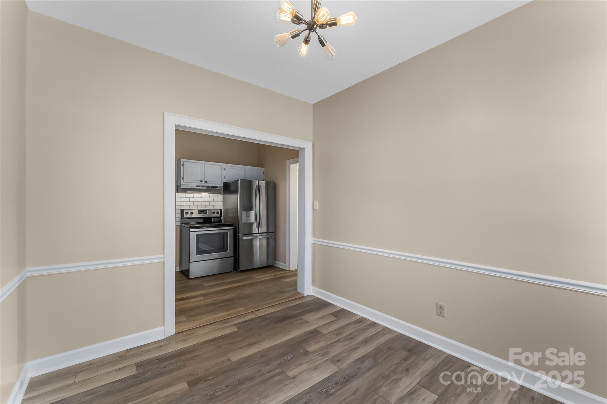 308 North Green Street, Unit 6 Morganton, NC 28655 - Photo 10 of 21 a view of a kitchen with a sink a ceiling fan and a stove