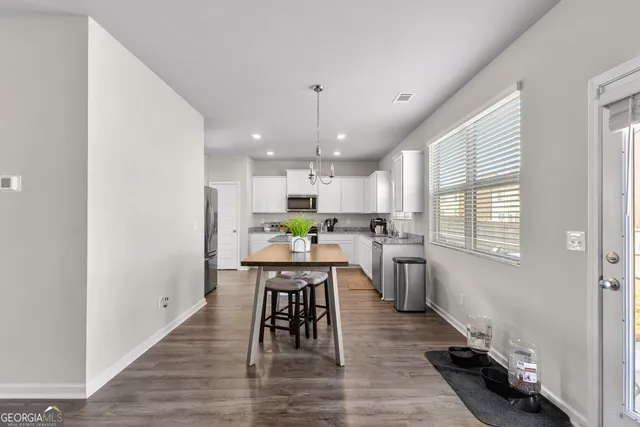 a kitchen with a table and chairs in it