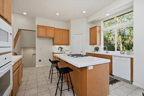 a kitchen with a stove a sink and a refrigerator