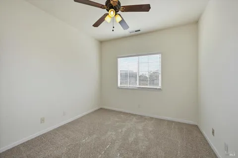 a bathroom with a sink a toilet and shower curtain