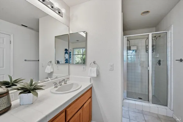 a balcony with wooden floor table and chairs