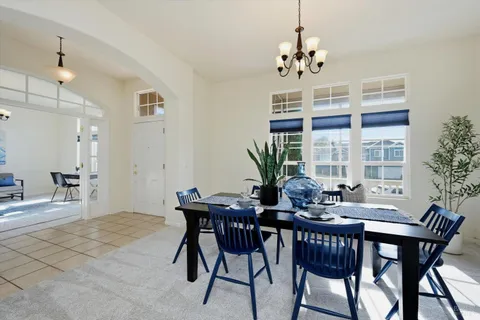 a view of a dining room with furniture and chandelier