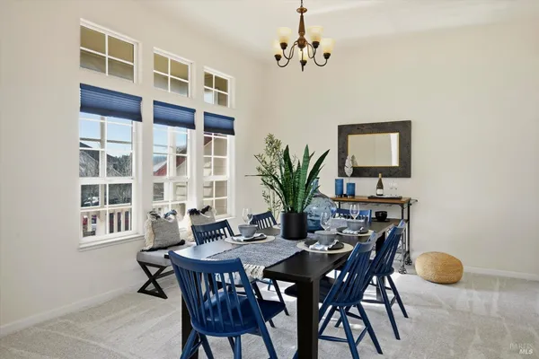 a living room with furniture and potted plant