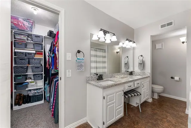 a bathroom with a granite countertop bathtub shower sink and mirror