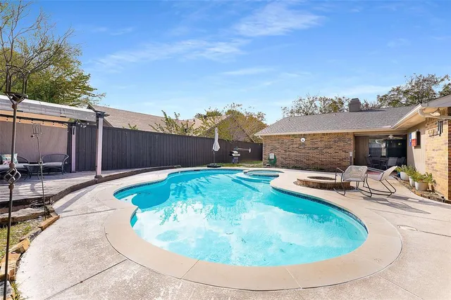 a swimming pool with outdoor seating and yard