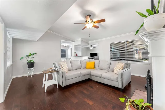a living room with furniture wooden floor and a chandelier