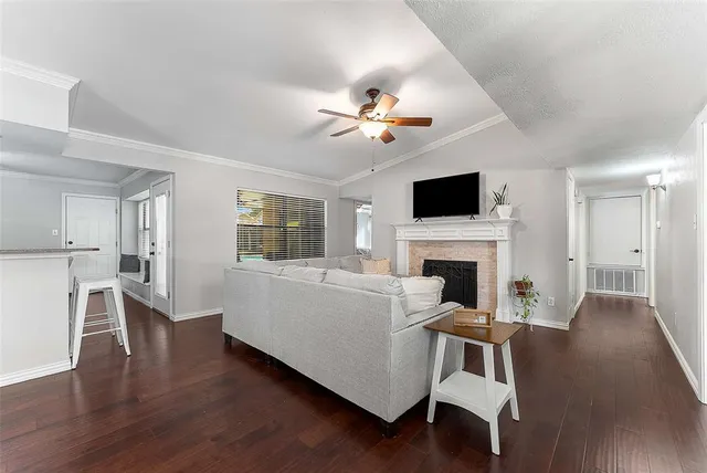 a living room with furniture a fireplace and a flat screen tv