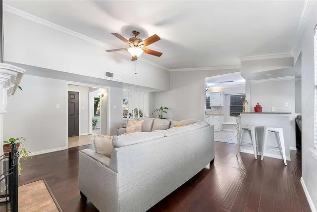a living room with furniture and kitchen view