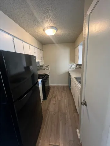 a kitchen with stainless steel appliances a refrigerator and a stove