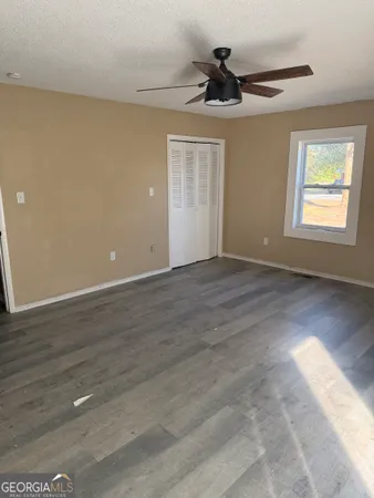 a view of an empty room and wooden floor