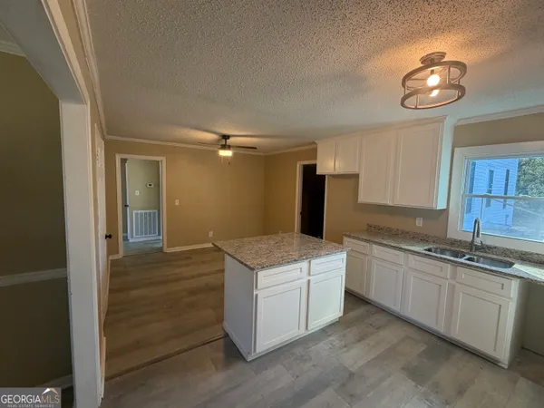 a kitchen that has a sink and cabinets