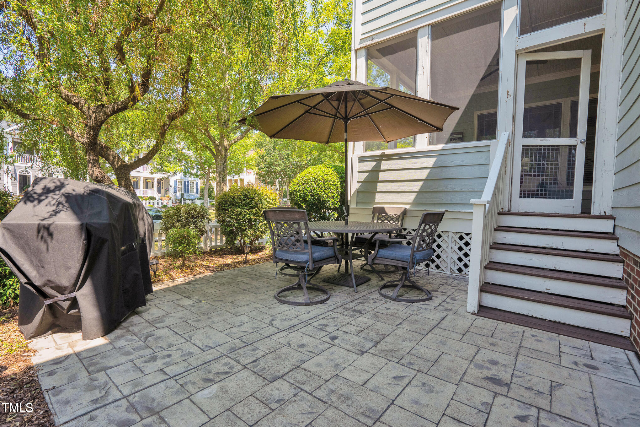 1700 Rainbow Hill Raleigh, NC 27614 - Photo 32 of 35 a view of a patio with table and chairs under an umbrella