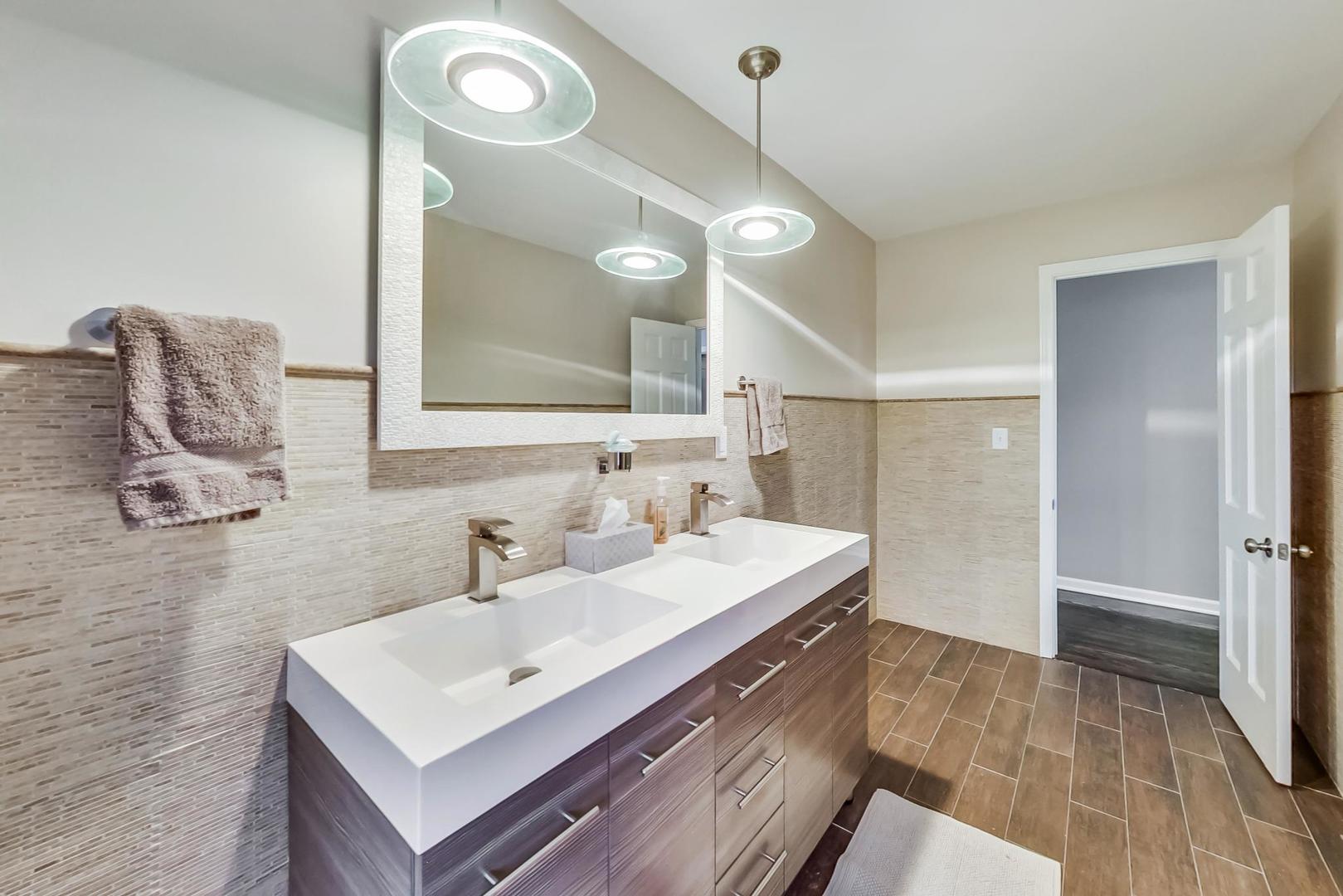 600 F Aberdeen Road Frankfort, IL 60423 - Photo 54 of 60 a bathroom with a sink a mirror a vanity and shower