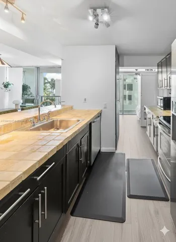 a large kitchen with a wooden floor and cabinets