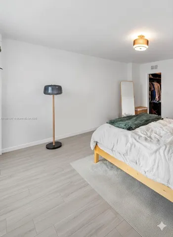 a bedroom with a bed and a lamp