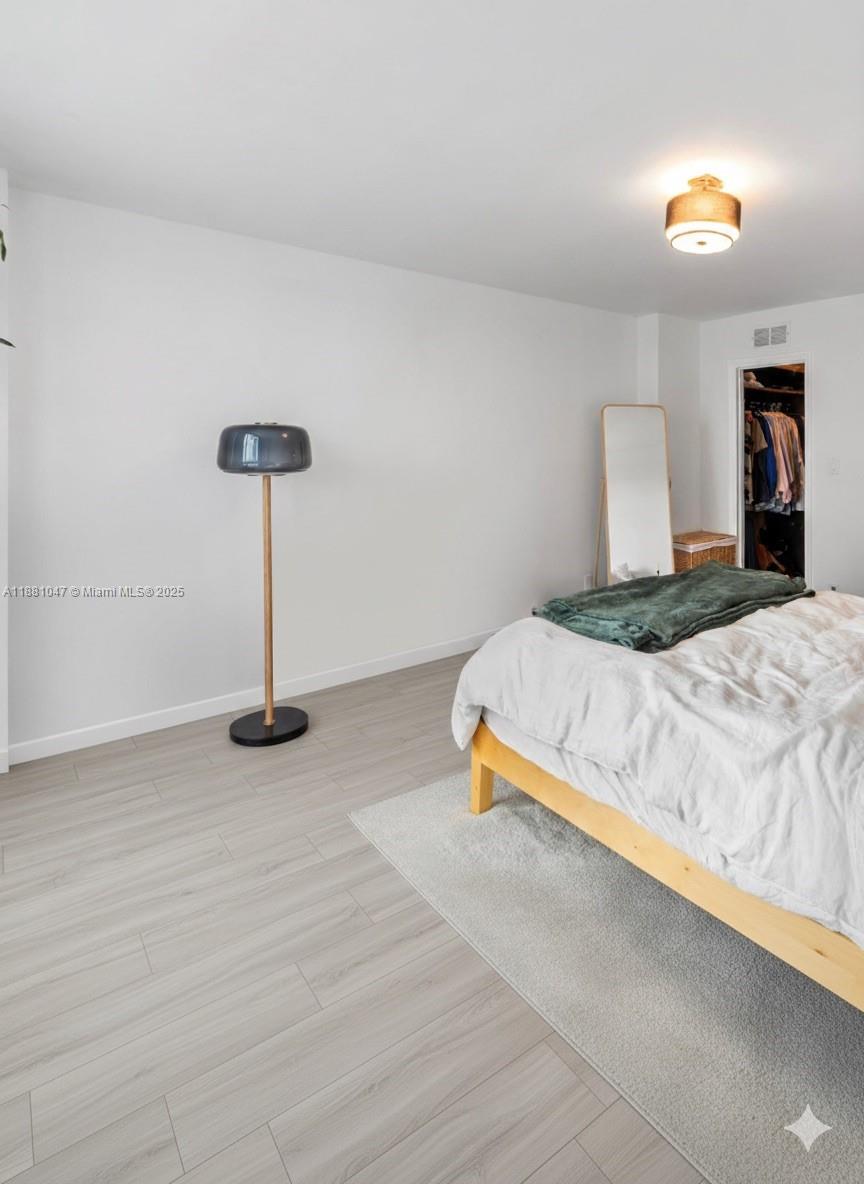 2655 Collins Avenue, Unit 510 Miami Beach, FL 33140 - Photo 15 of 23 a bedroom with a bed and a lamp