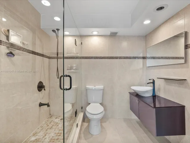 a bathroom with a toilet sink and shower