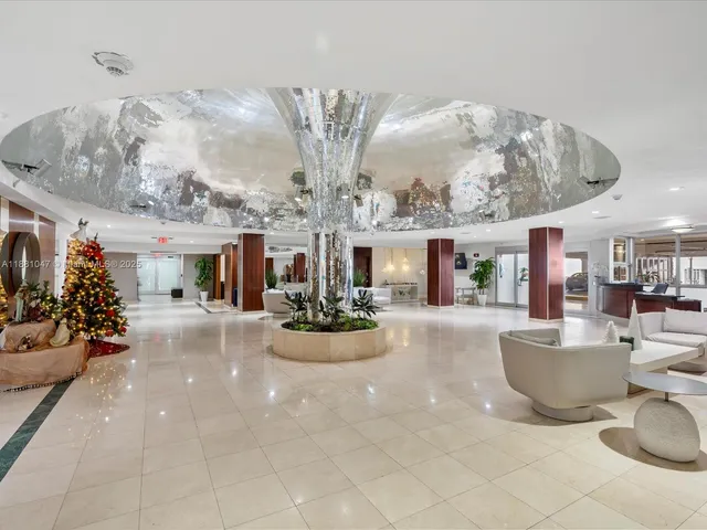 a view of living room kitchen with furniture and chandelier
