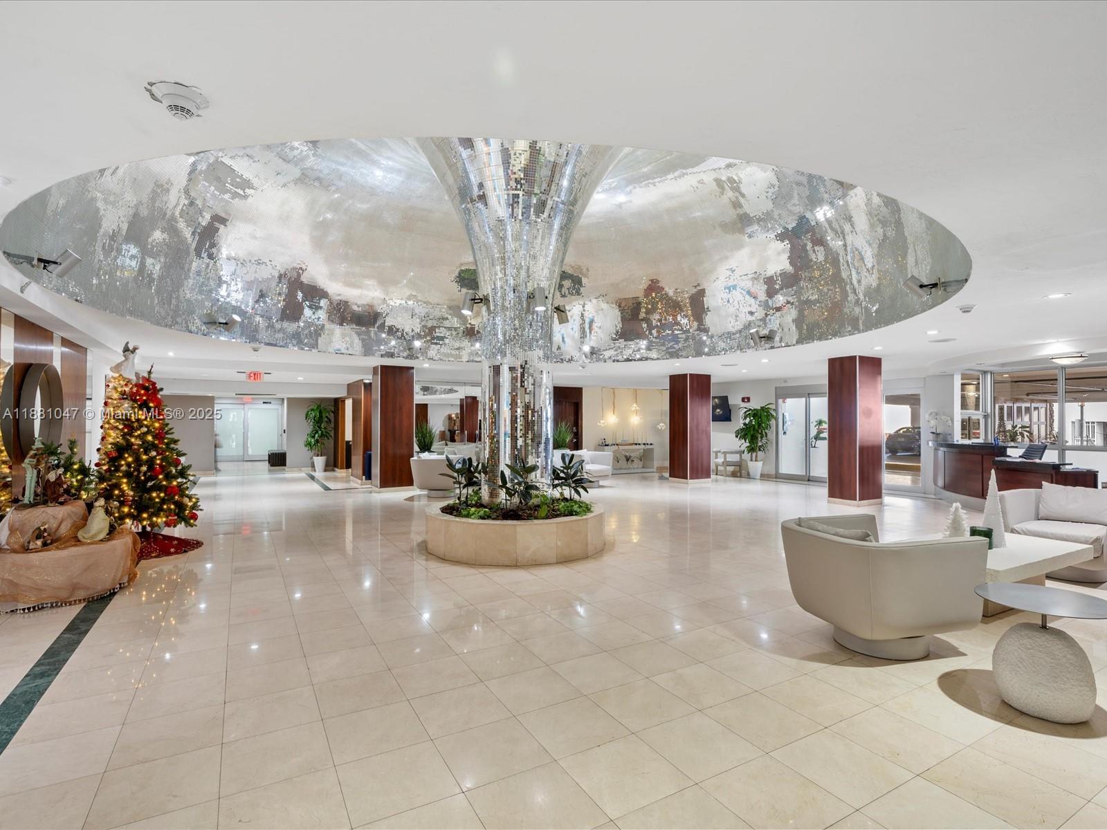 2655 Collins Avenue, Unit 510 Miami Beach, FL 33140 - Photo 2 of 23 a view of living room kitchen with furniture and chandelier