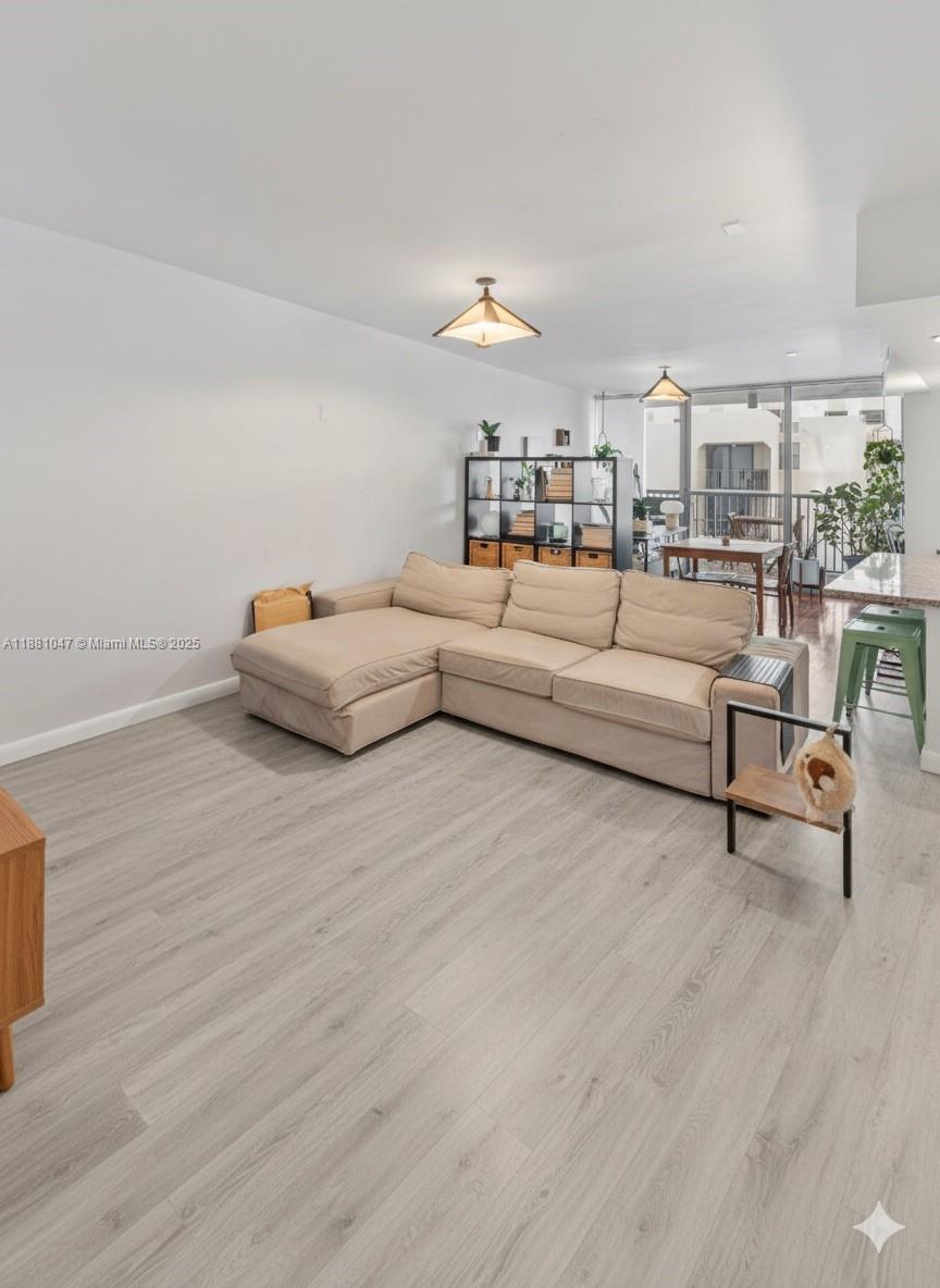 2655 Collins Avenue, Unit 510 Miami Beach, FL 33140 - Photo 5 of 23 a living room with furniture and a wooden floor