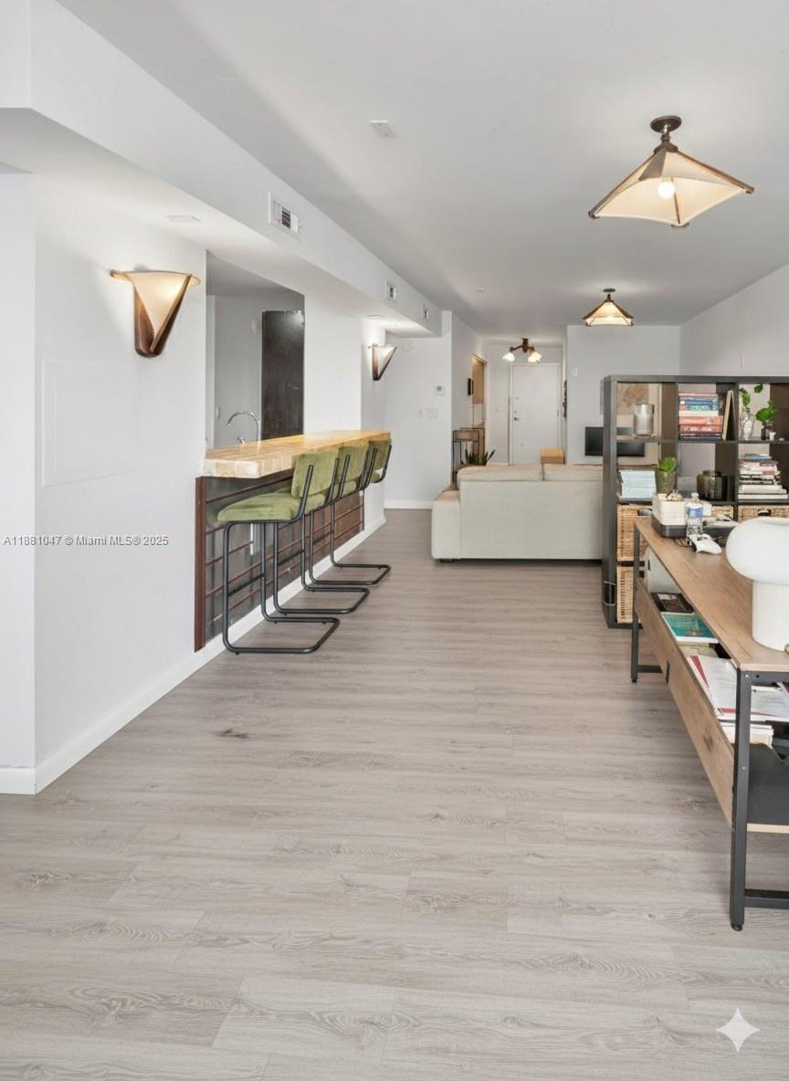 2655 Collins Avenue, Unit 510 Miami Beach, FL 33140 - Photo 7 of 23 a living room with furniture and a flat screen tv