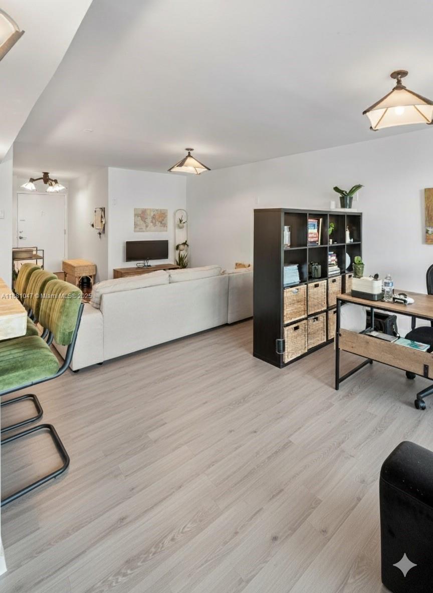 2655 Collins Avenue, Unit 510 Miami Beach, FL 33140 - Photo 9 of 23 a living room with furniture and a wooden floor