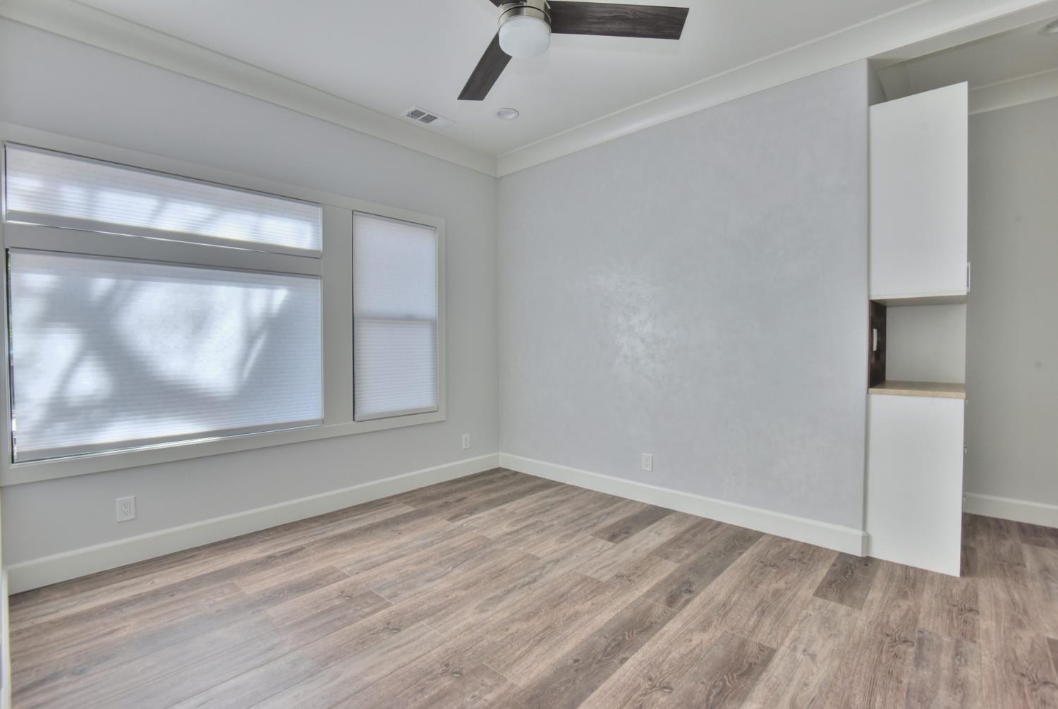 251 Middlefield Road Palo Alto, CA 94301 - Photo 36 of 76 a view of an empty room with wooden floor and a window