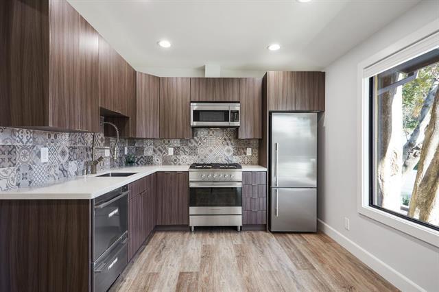 251 Middlefield Road Palo Alto, CA 94301 - Photo 52 of 76 a kitchen with stainless steel appliances granite countertop a refrigerator a sink and wooden cabinets