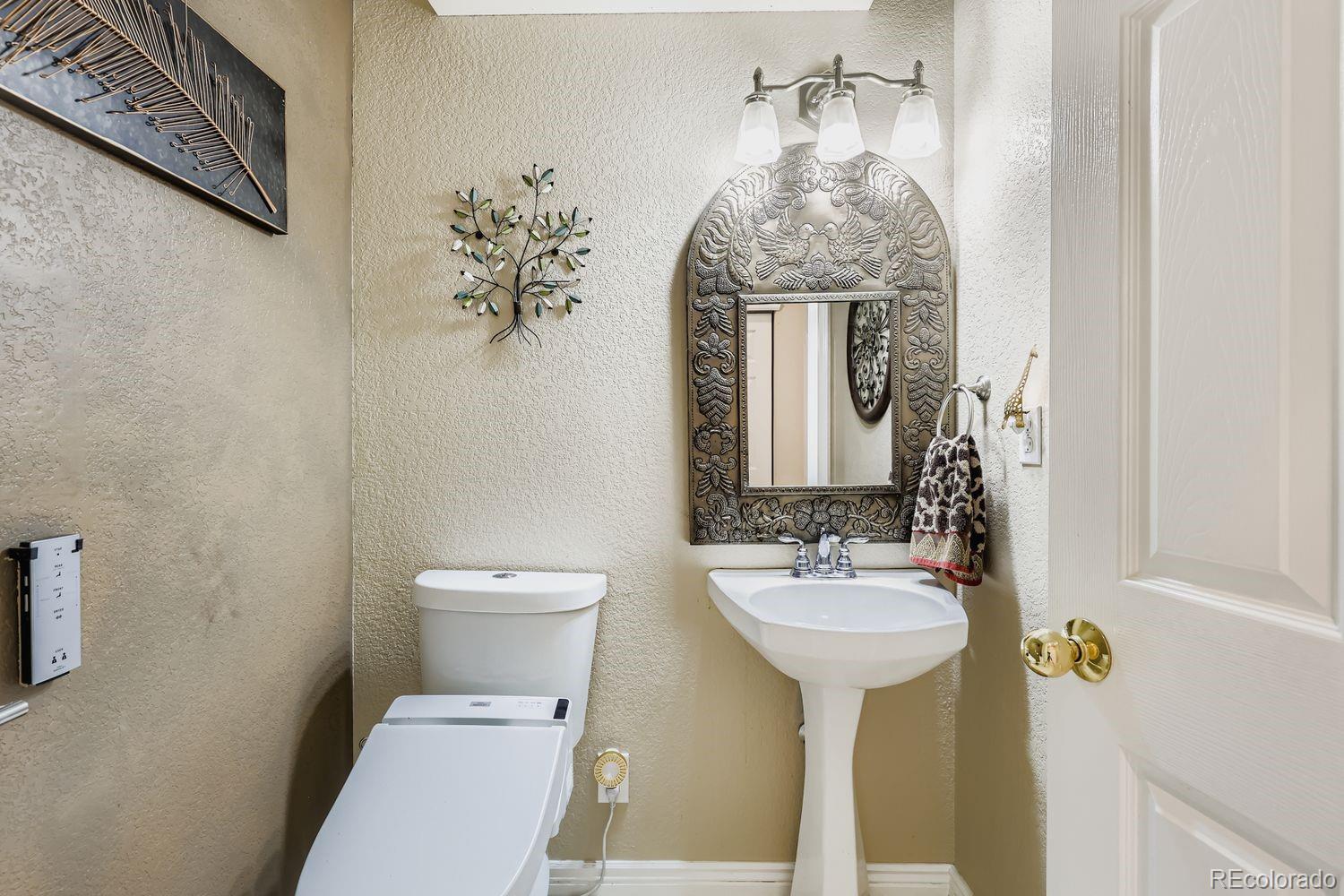 10752 Zuni Drive Denver, CO 80234 - Photo 12 of 27 a bathroom with a toilet sink and mirror