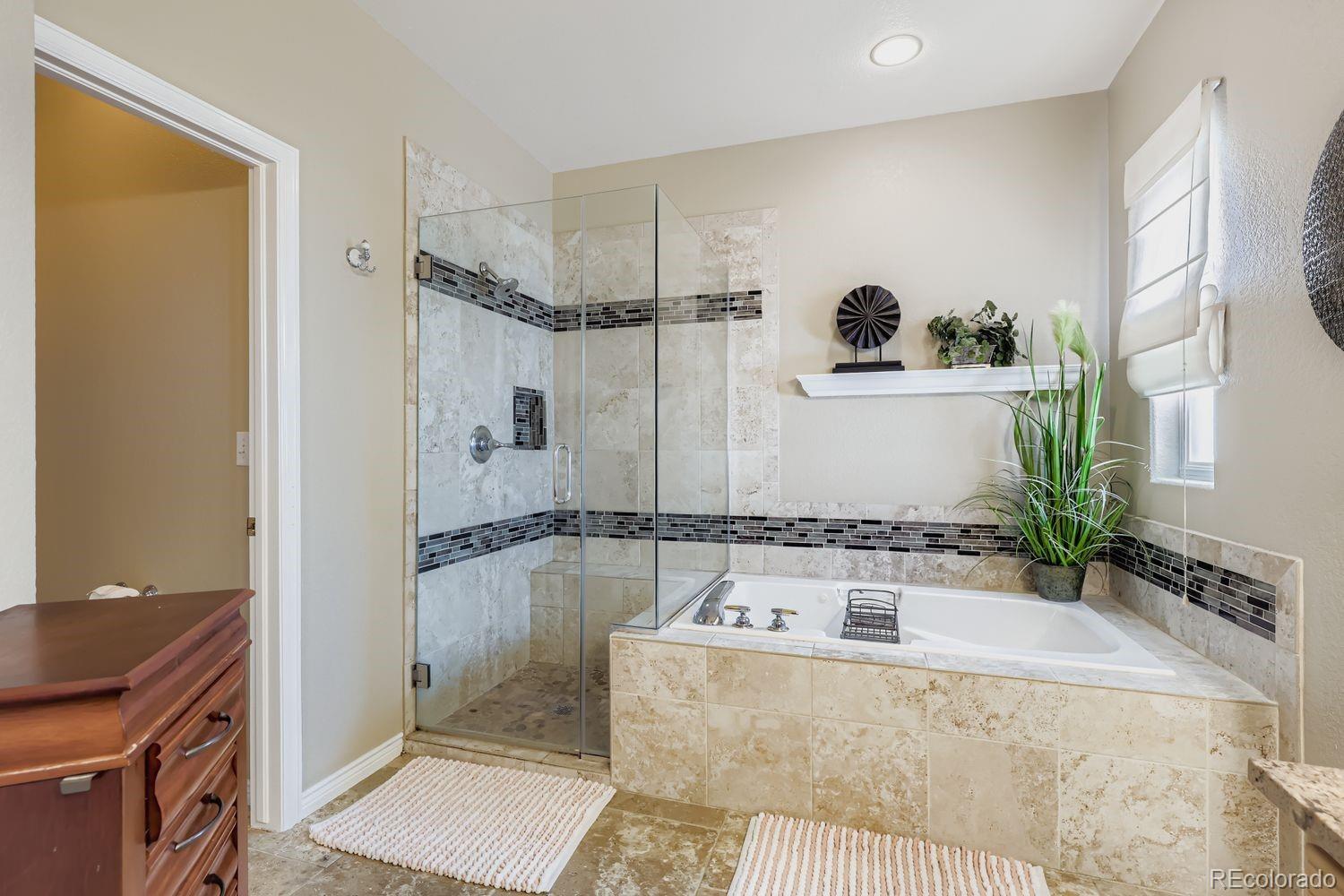 10752 Zuni Drive Denver, CO 80234 - Photo 15 of 27 a bathroom with a granite countertop tub sink and mirror