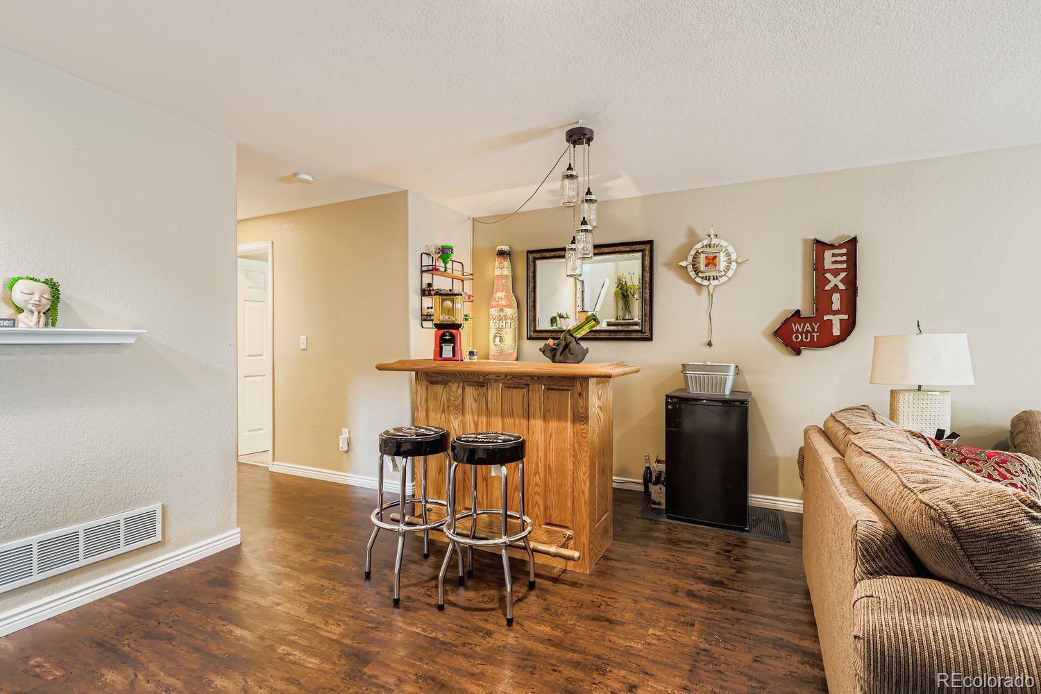 10752 Zuni Drive Denver, CO 80234 - Photo 17 of 27 a living room with furniture and painting on the wall