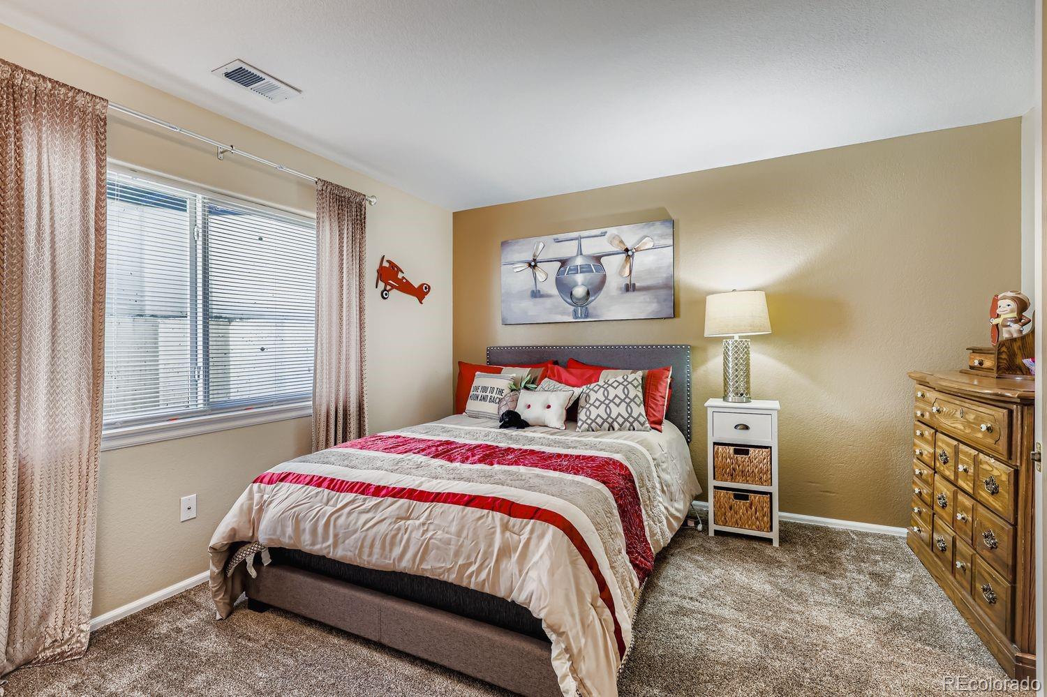 10752 Zuni Drive Denver, CO 80234 - Photo 20 of 27 a bedroom with a bed and a window