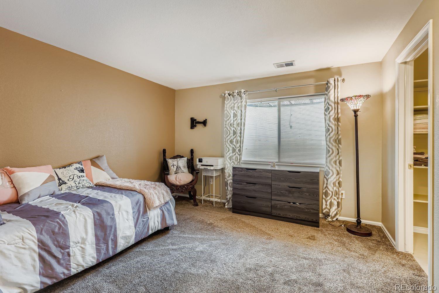 10752 Zuni Drive Denver, CO 80234 - Photo 21 of 27 a bedroom with a bed and a window