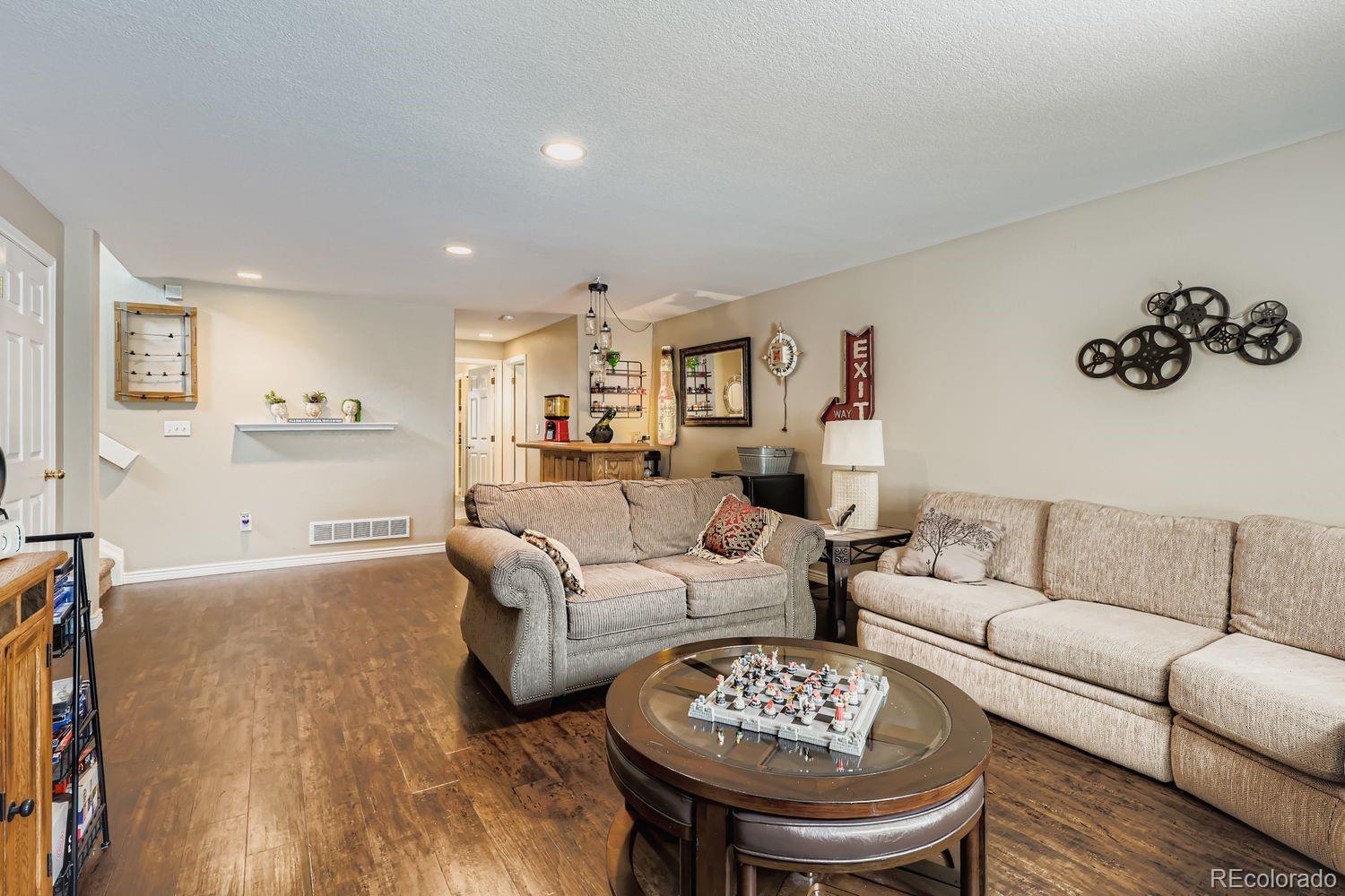 10752 Zuni Drive Denver, CO 80234 - Photo 23 of 27 a living room with furniture and a view of kitchen