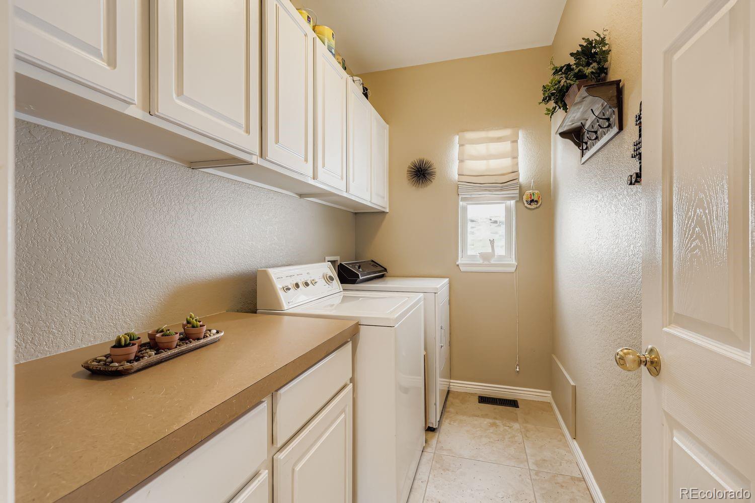 10752 Zuni Drive Denver, CO 80234 - Photo 25 of 27 a utility room with sink dryer and washer