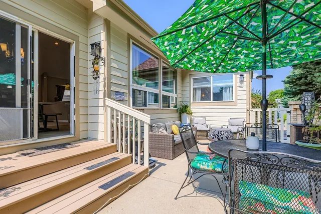 a view of a house with backyard and sitting area