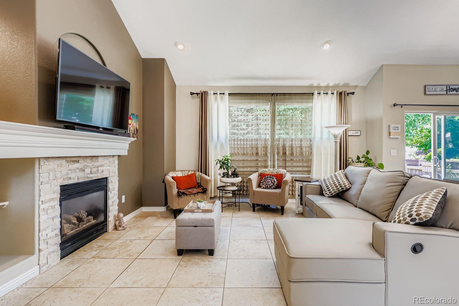 10752 Zuni Drive Denver, CO 80234 - Photo 6 of 27 a living room with furniture and a fireplace