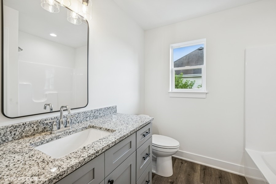 735 Fox Trail Terrace Cary, IL 60013 - Photo 11 of 21 a bathroom with a granite countertop sink a toilet and a mirror