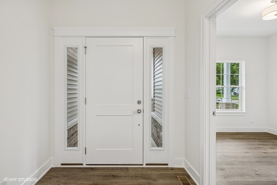 735 Fox Trail Terrace Cary, IL 60013 - Photo 2 of 21 a view of an empty room with wooden floor and a window