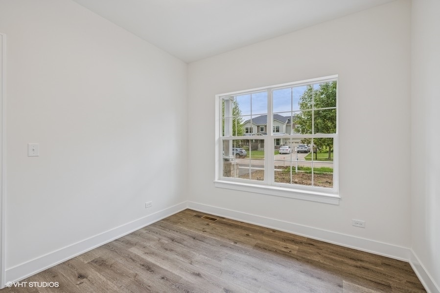735 Fox Trail Terrace Cary, IL 60013 - Photo 3 of 21 an empty room with wooden floor and windows
