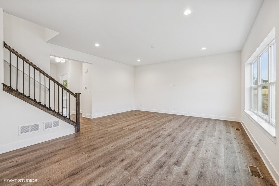 735 Fox Trail Terrace Cary, IL 60013 - Photo 5 of 21 wooden floor in an empty room with a window