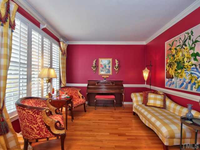 9437 Macon Road Raleigh, NC 27613 - Photo 4 of 25 Great formal living room with a lot of natural light, hardwoods, crown molding and chair railing. Living Room