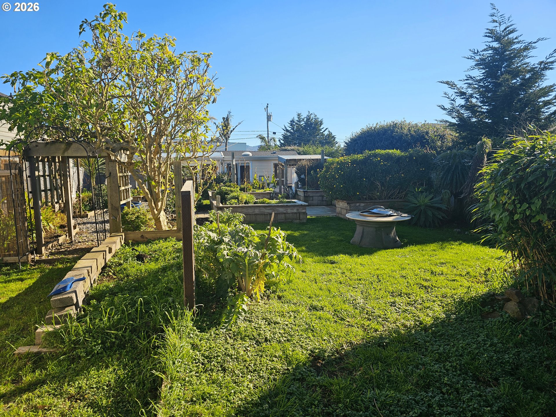 237 Wharf Street Brookings, OR 97415 - Photo 19 of 27 a view of a garden with a house